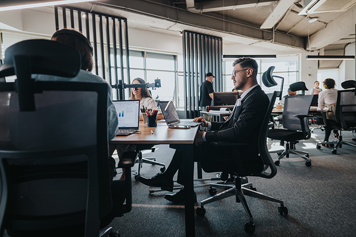 Team of business people at desks in an office – representing T2P Recruitment’s finance sector