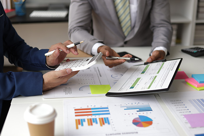 Businessman planning and analysing company financial reports, representing T2P Recruitment specialising in financial roles.