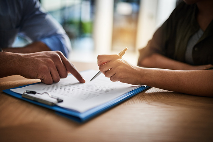 T2P Recruitment specialists office photo of close up of man and a womans hands completing paperwork
